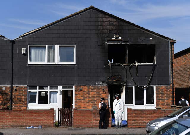 Police and forensics officers at the scene of the fire 