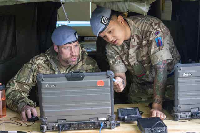 The Prince of Wales (left) gets a briefing of overseas operations during a visit to Wattisham flying station