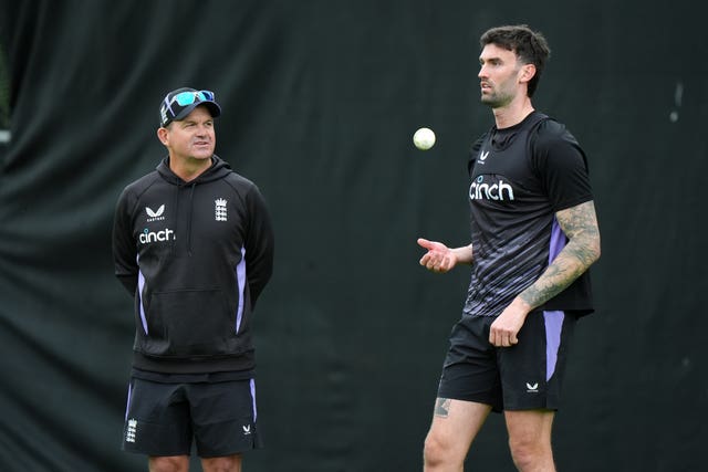 Matthew Mott looks on as Reece Topley prepares to bowl in an England training session