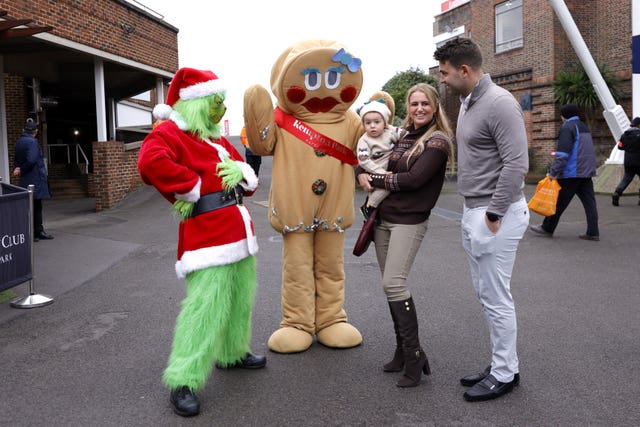 Racegoers pose with performers in Christmas fancy dress outfits 