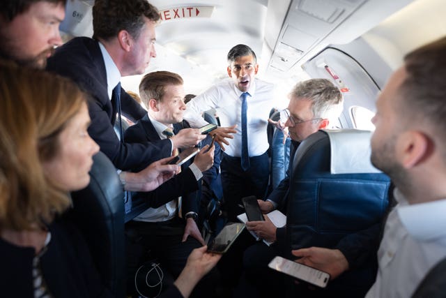 Prime Minister Rishi Sunak talks to journalists on his plane as he travels from Northern Ireland to Birmingham 