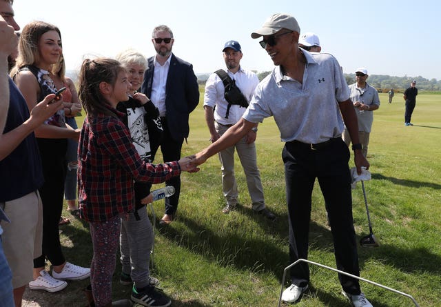 Former US president Barack Obama shakes hands with the public at the home of golf (Andrew Milligan/PA)