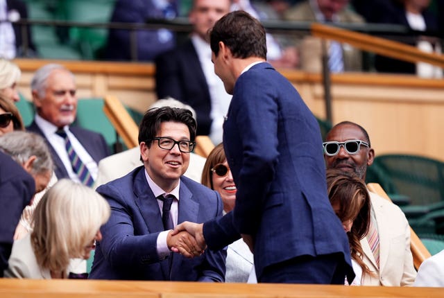 Comedian Michael McIntyre, left, meets eight-time Wimbledon champion Roger Federer in the Royal Box