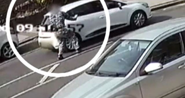 CCTV image of John Tomlin throwing a substance into a car (Metropolitan Police/PA)