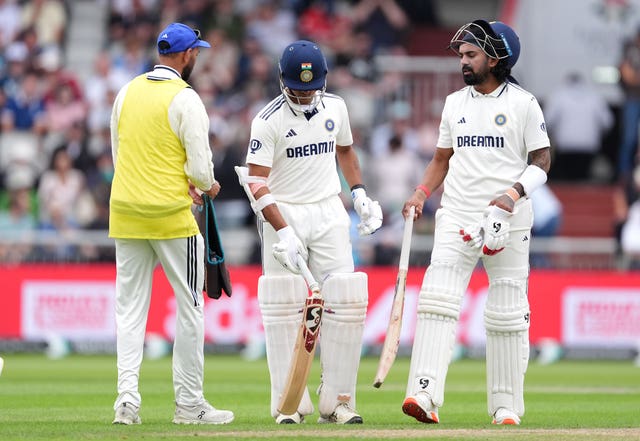 India’s Yashasvi Jaiswal (centre) holds a broken bat during a stop in play