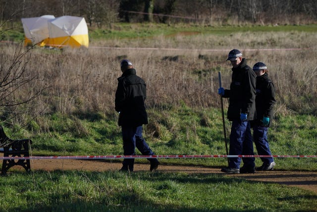 Forensic tents and a police search team at the scene at Hanworth Park, Feltham, following the death of Tyler Donnelly, whose body was found in west London. PA.