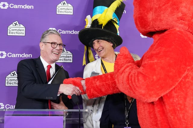 Labour leader Sir Keir Starmer shakes hands with Nick the Incredible Flying Brick (second right) and Bobby “Elmo” Smith (right)