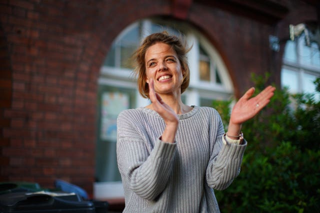 Annemarie Plas, a Dutch national living in south London who created the weekly 8pm Clap for Carers, applauds alongside her neighbours 