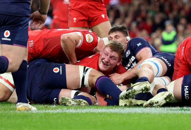 Rhys Carre celebrates his try against Scotland