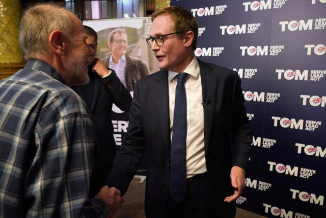 Tom Tugendhat shakes hands with a supporter during his leadership campaign launch