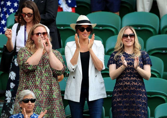 The Duchess of Sussex, centre, was in the crowd to watch Serena Williams