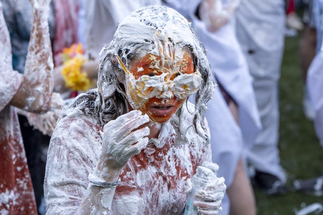 A student in glasses covered in shaving foam