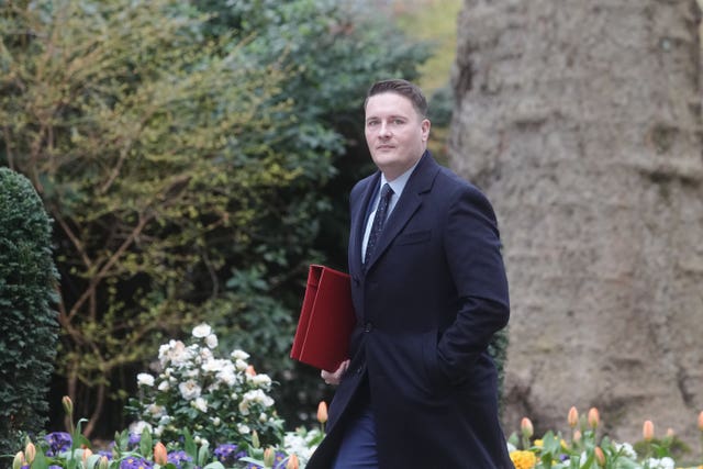 Wes Streeting walking with a folder under his arm on Downing Street