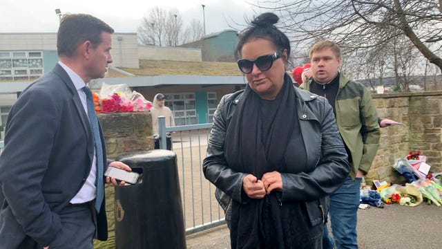 Caroline Willgoose leaving All Saints Catholic High School in Sheffield after viewing tributes left to her son, Harvey