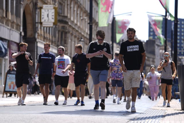 Oasis fans walk through the centre of Cardiff