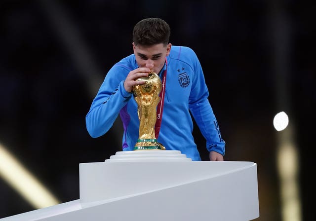 Julian Alvarez kisses the World Cup trophy