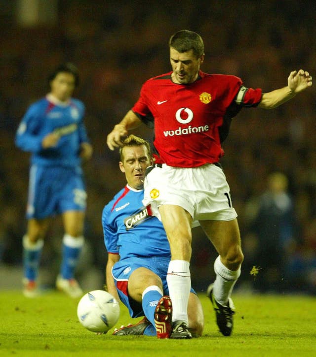 Fernando Ricksen tangles with Roy Keane during a clash with Manchester United 