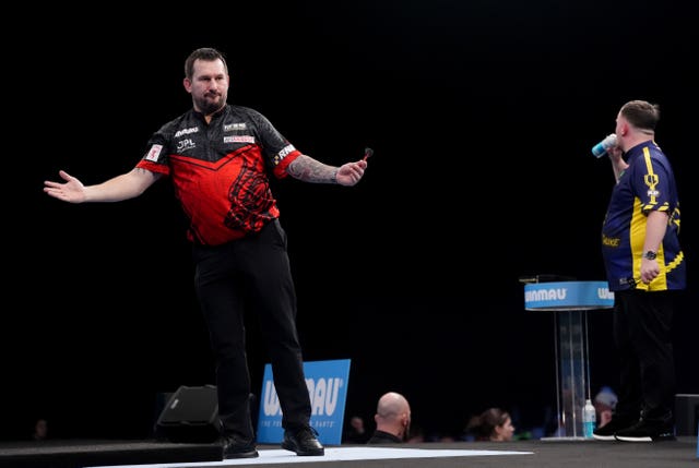 Jonny Clayton celebrates after winning his quarter-final match against Luke Littler