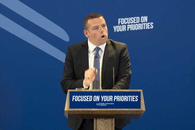 Douglas Ross speaking at a Tory lectern