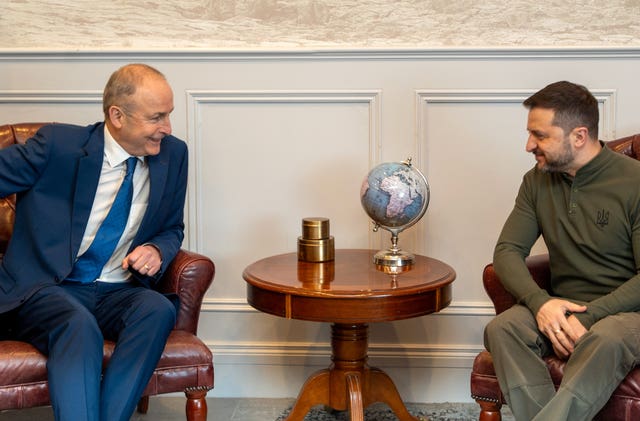 Taoiseach Micheal Martin sitting across from Volodymyr Zelensky 